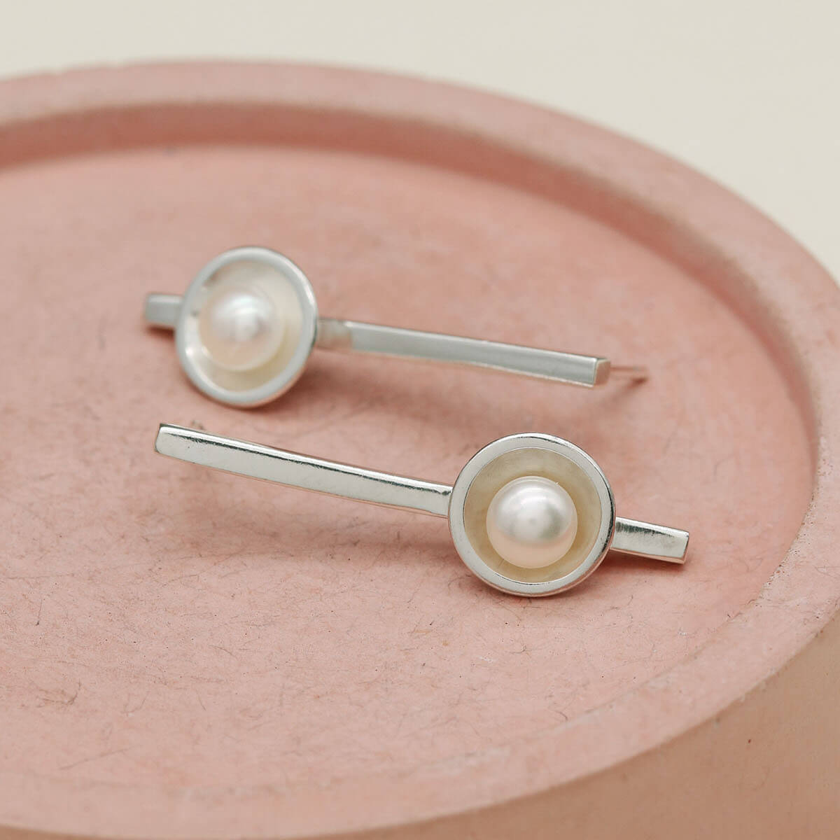 Long pearl earrings handcrafted from solid sterling silver featuring luminous freshwater pearls and an elegant 30mm bar.