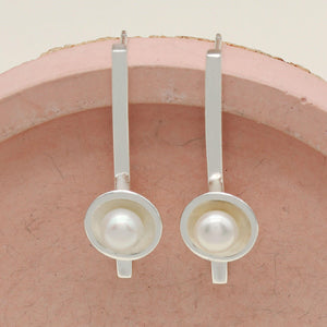 Handmade pearl hanging earrings with polished sterling silver bars and genuine freshwater pearls.