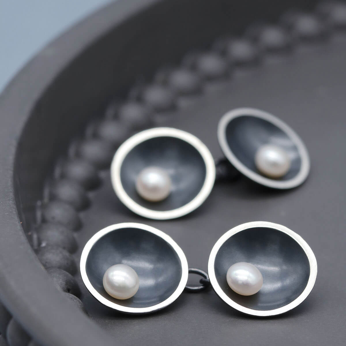 Art Deco inspired black pearl cufflinks with double-sided chain design and genuine freshwater pearls.
