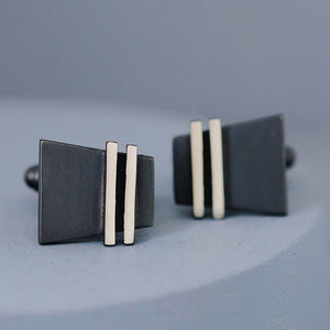 Handcrafted black cufflinks arranged together to highlight minimalist geometric design. A thoughtful birthday gift for husband or partner.