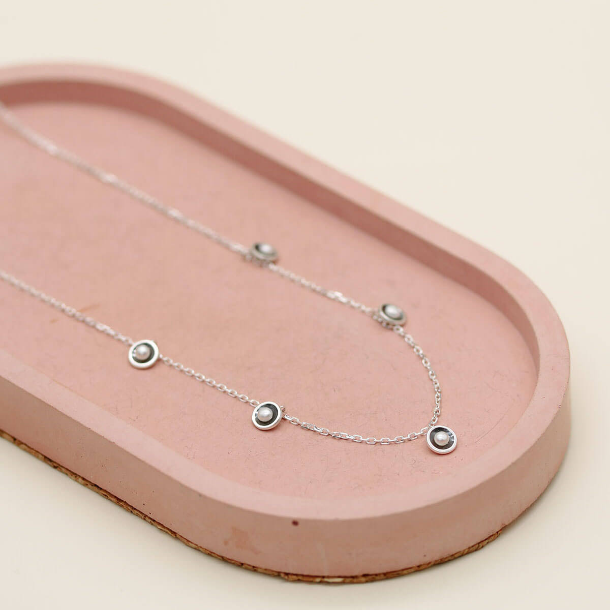 Handmade mini pearl necklace crafted in oxidised sterling silver with evenly spaced freshwater pearls along the chain.