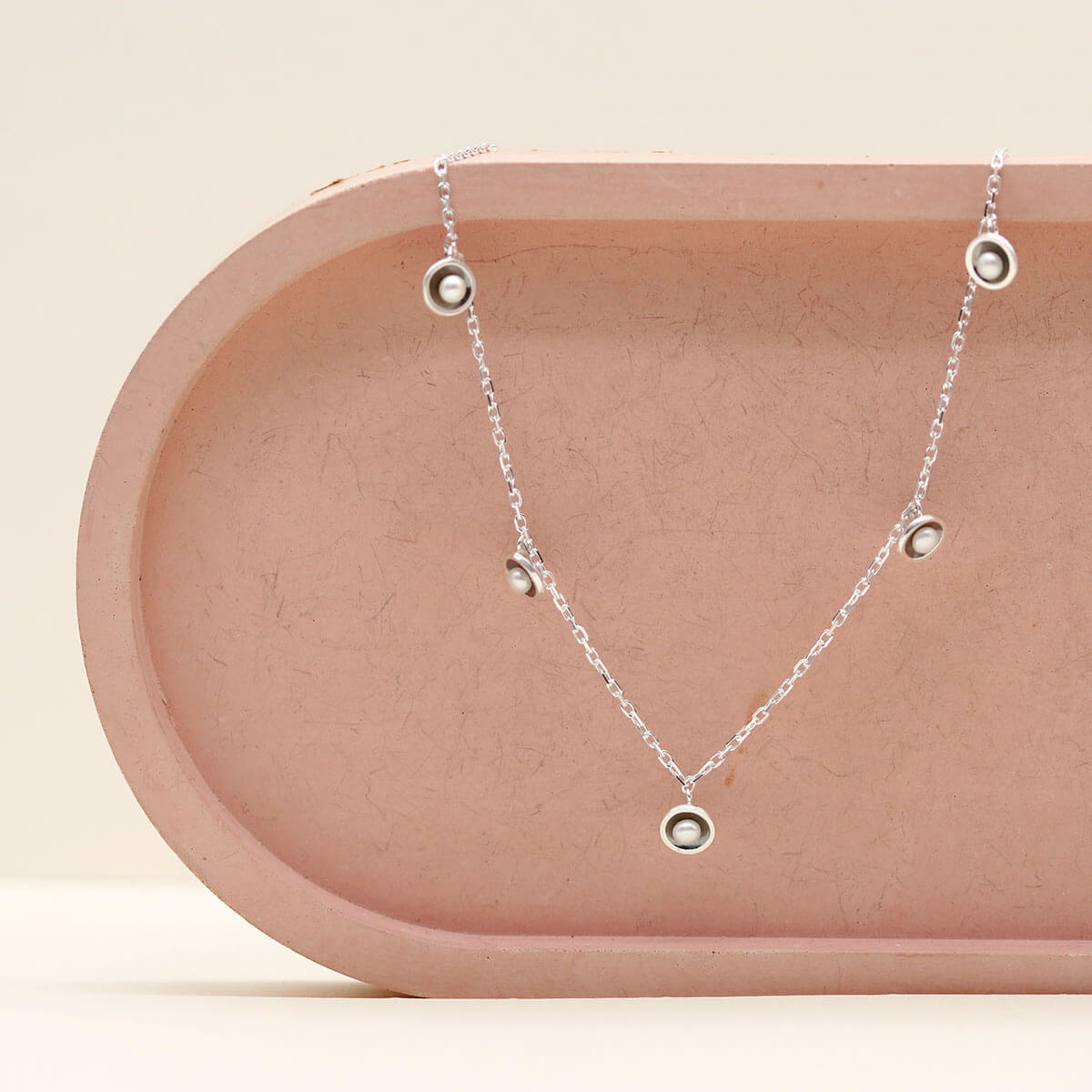 Layering pearl necklace with five genuine freshwater pearls on an adjustable 16 to 18 inch sterling silver curb chain.