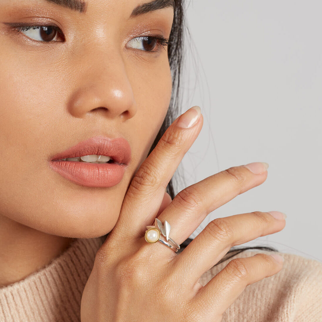 Woman wearing a handmade silver statement ring with an Art Deco fan design, styled as an everyday statement piece