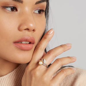 Woman wearing a handmade silver statement ring with an Art Deco fan design, styled as an everyday statement piece