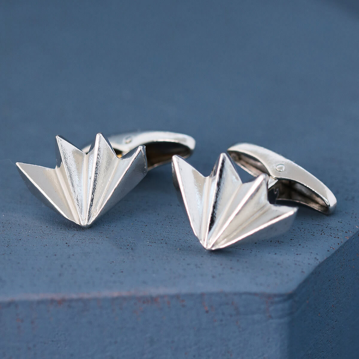 Pair of fan-shaped art deco cufflinks on deep blue background, modern men’s silver cufflinks ideal for groom or best man gift