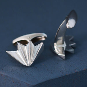 Angle view of geometric art deco cufflinks on deep blue background, sterling silver cufflinks for stylish men’s wedding attire