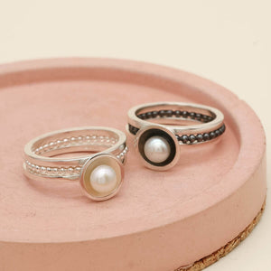 Black pearl stacking ring set shown alongside the polished sterling silver version