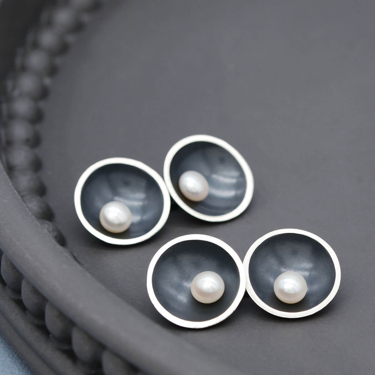 Close up of Art Deco pearl cufflinks showing traditional silversmithing craftsmanship and double-sided construction.