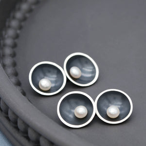 Close up of Art Deco pearl cufflinks showing traditional silversmithing craftsmanship and double-sided construction.