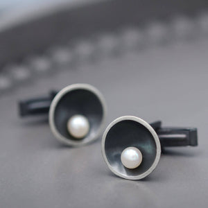 Black pearl cufflinks for men handcrafted in sterling silver with a modern Art Deco inspired design.