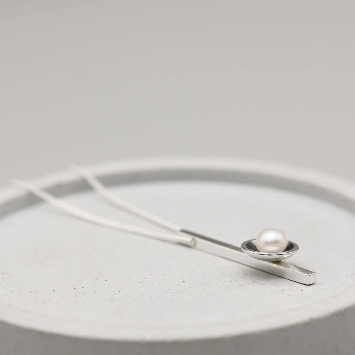 Elegant black pearl bar necklace with a 5mm freshwater pearl and sleek sterling silver bar pendant.