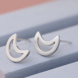 Close-up of handcrafted silver moon earrings in solid sterling silver