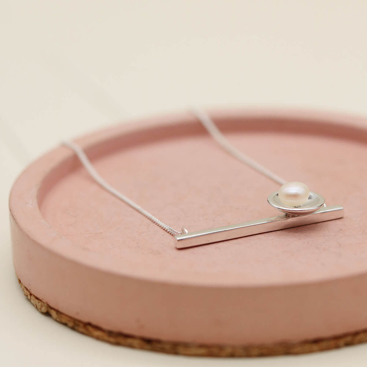 Contemporary pearl necklace handcrafted in sterling silver with a genuine freshwater pearl and geometric horizontal pendant.