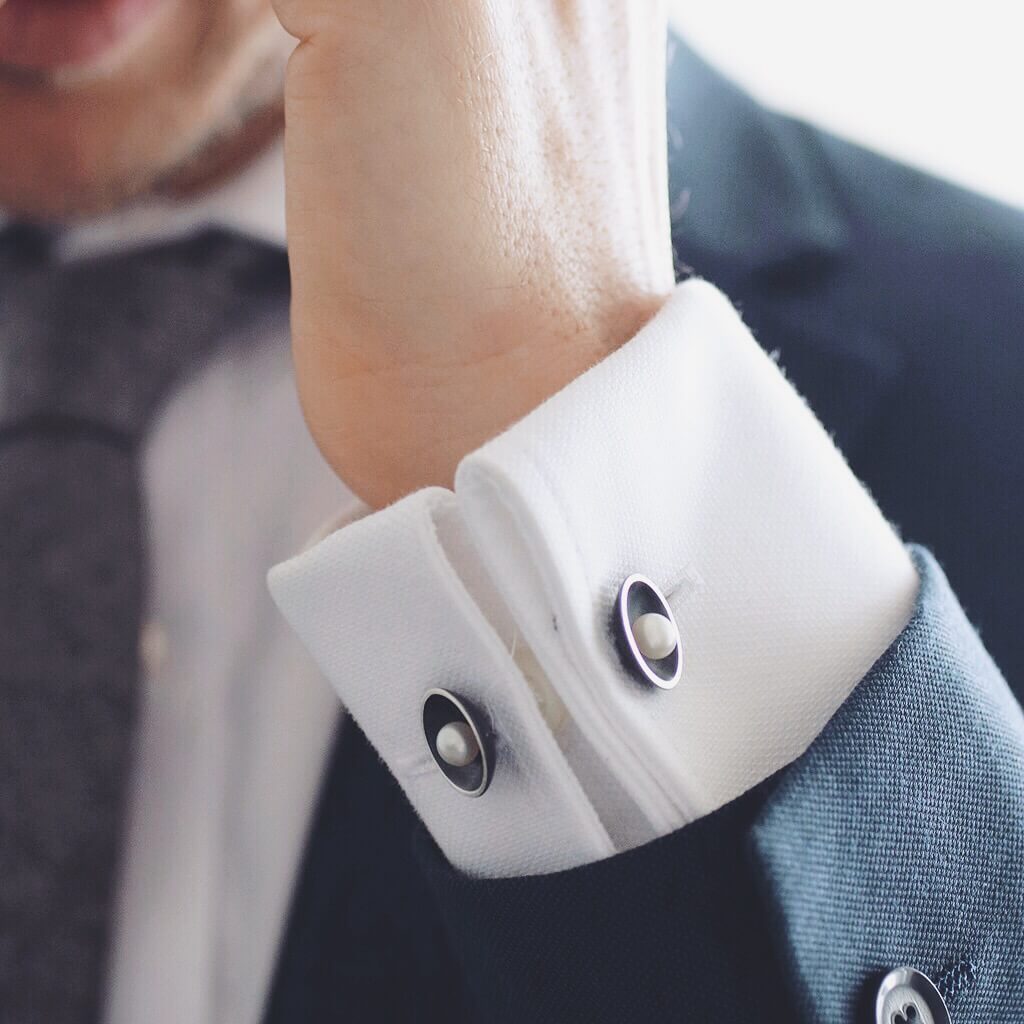 Double-sided pearl cufflinks worn on a white shirt, featuring genuine freshwater pearls and Art Deco inspired styling.