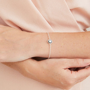 Handmade pearl and sterling silver bracelet worn on its own, featuring the oxidised sterling silver pearl setting and genuine freshwater pearl against the skin.