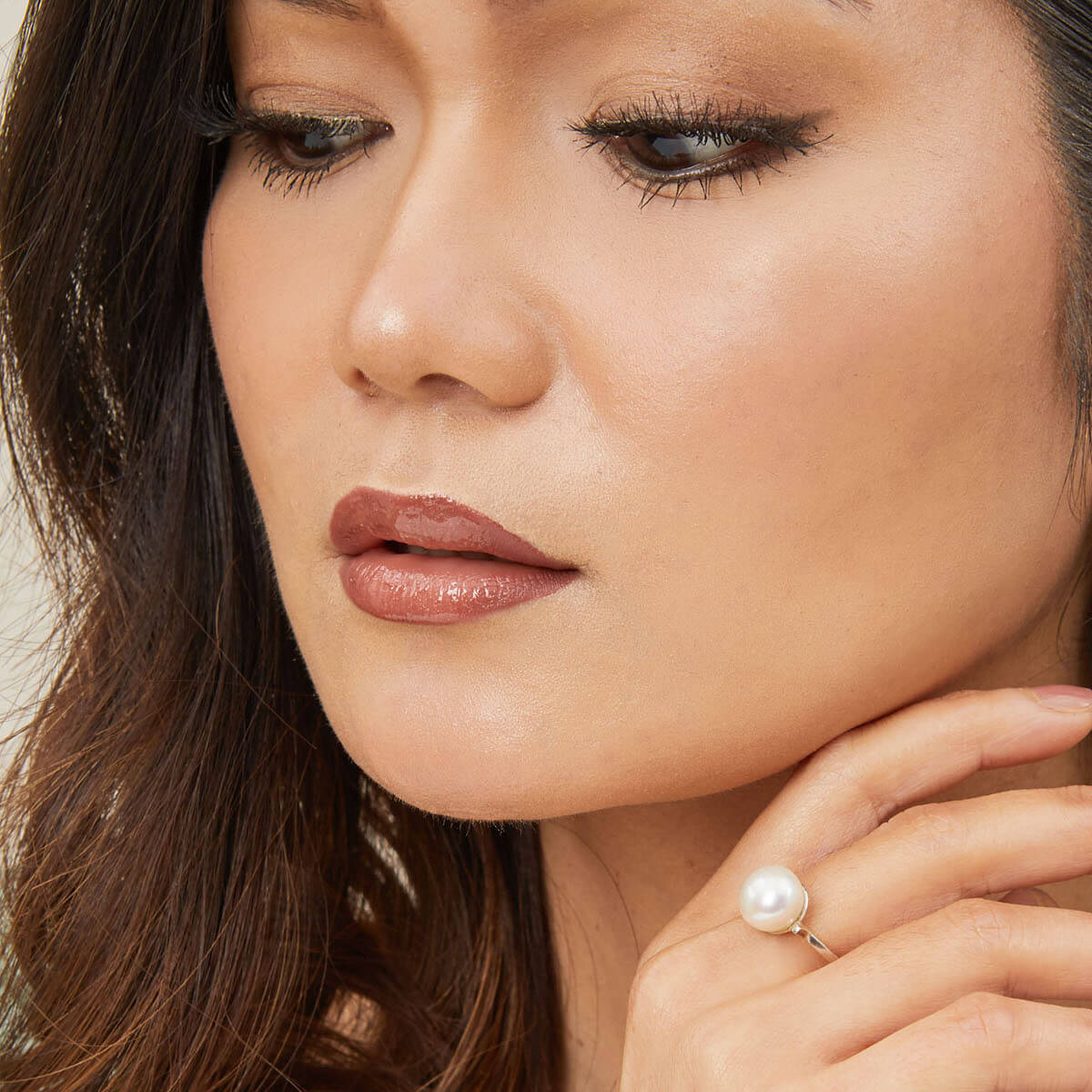 Model wearing a large pearl cocktail ring with ivory white freshwater pearl