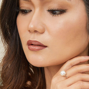 Model wearing a large pearl cocktail ring with ivory white freshwater pearl
