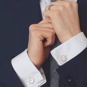 Sterling silver double-sided pearl cufflinks worn on a white dress shirt, showing pearls on both sides of the cuff.