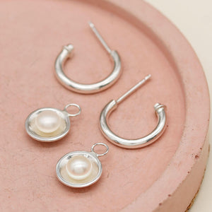 Elegant pearl drop hoop earrings with polished sterling silver hoops and genuine freshwater pearls.
