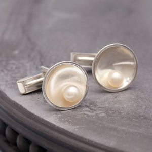 Close up of handmade pearl cufflinks for men showing polished sterling silver and natural freshwater pearls.