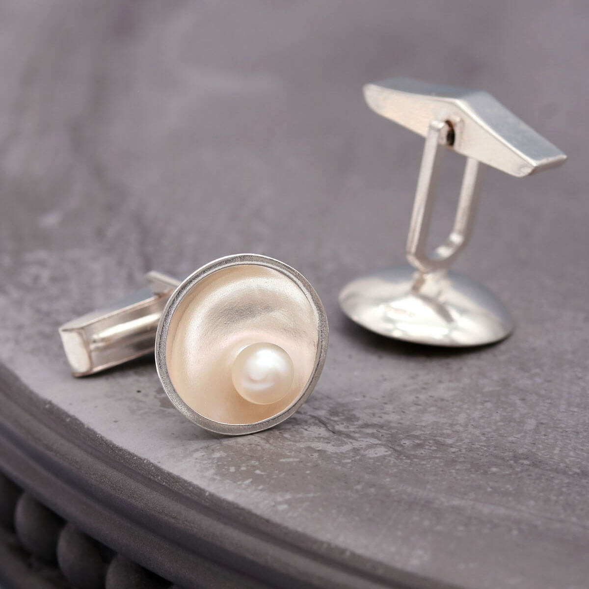 Handmade sterling silver cufflinks with freshwater pearls inspired by the elegance of Art Deco design.