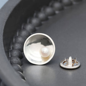 Detailed view of polished sterling silver pearl tie pin showcasing the shine of the silver and natural freshwater pearl.