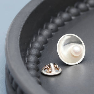 Close up of handmade sterling silver pearl tie pin highlighting the natural lustre of the freshwater pearl.