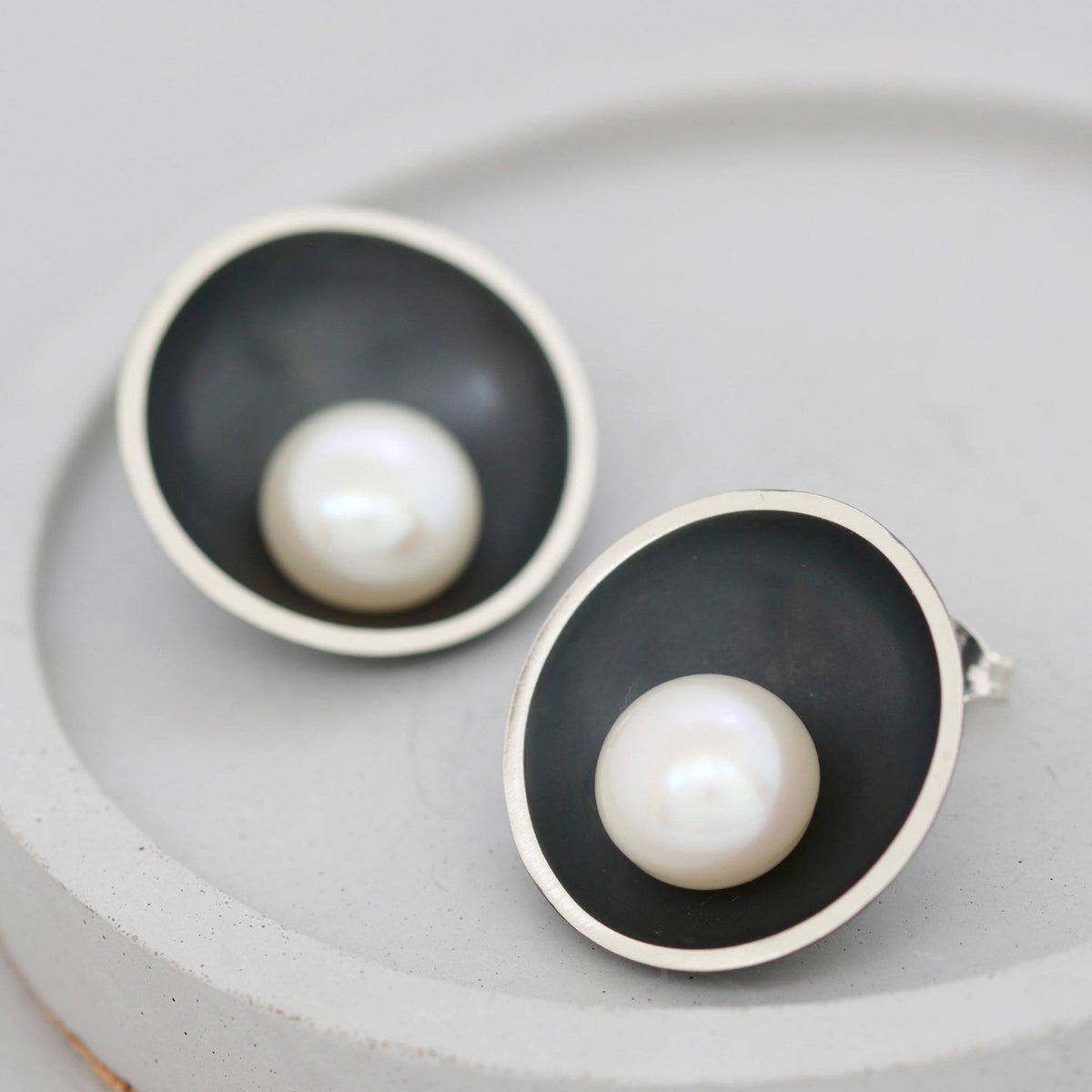 Black pearl stud earrings handcrafted in sterling silver with a freshwater pearl