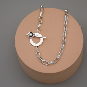 Detailed view of a sterling silver chunky pearl necklace showing the handcrafted T-bar clasp, rectangular trace chain and genuine freshwater pearl.