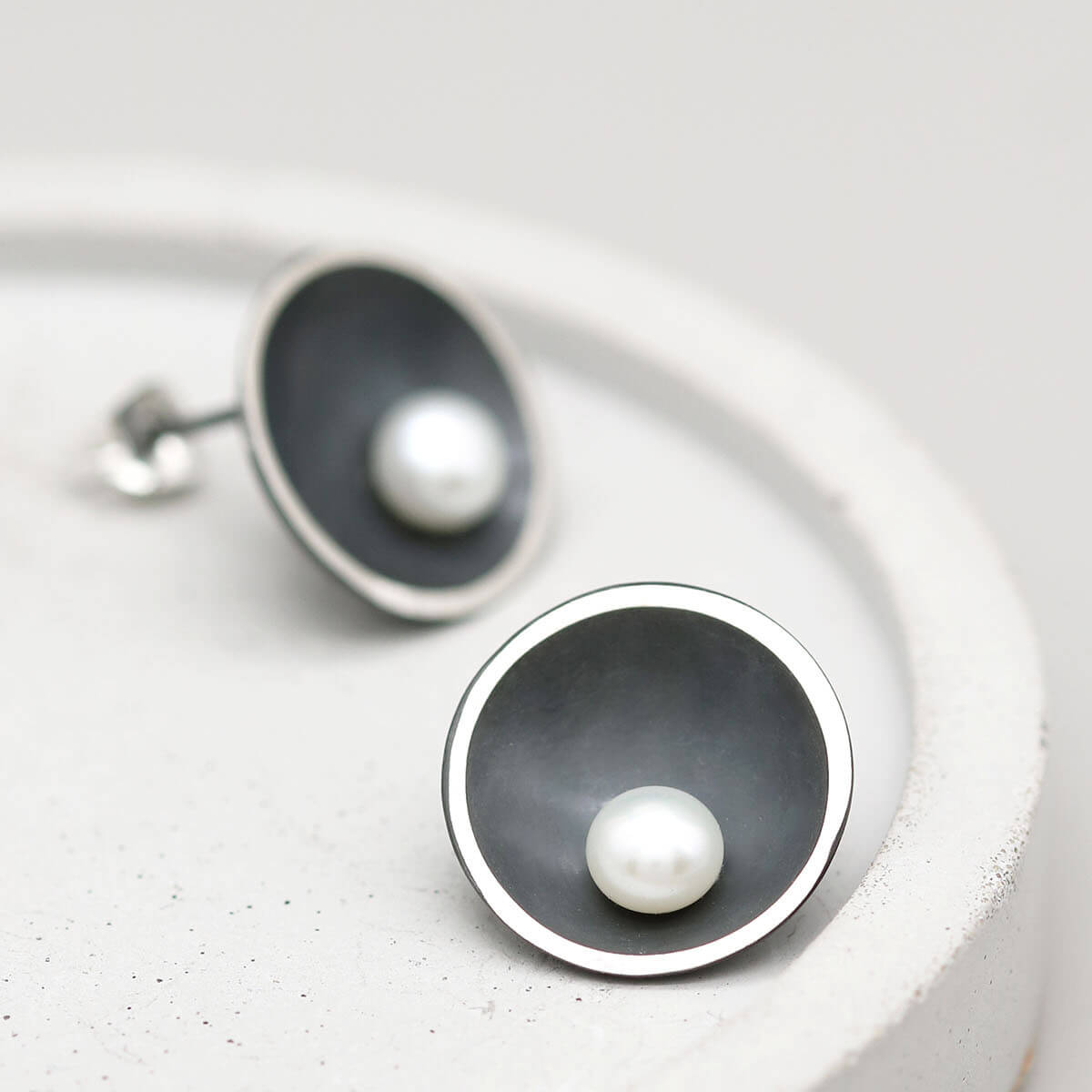 Handmade oxidised sterling silver pearl stud earrings with genuine freshwater pearls, inspired by elegant Art Deco design.