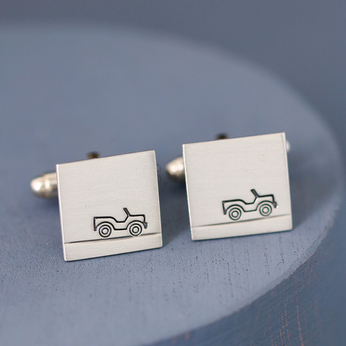 Up-close detail of car design hand-stamped on the silver surface, showcasing craftsmanship and perfect as a gift for car lovers.