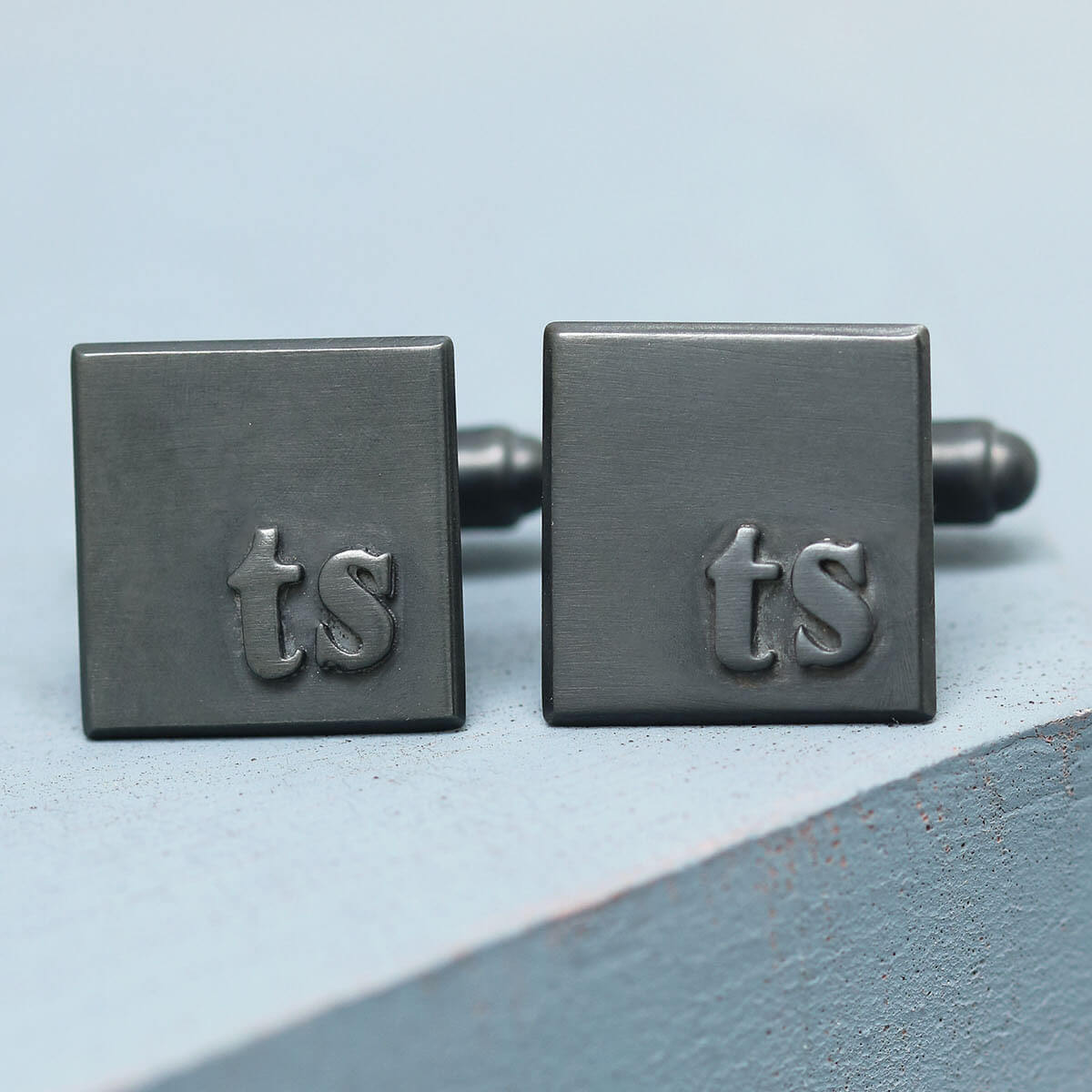 Personalised cufflinks for him with TS initials, handmade sterling silver cufflinks for a wedding, on a deep blue background