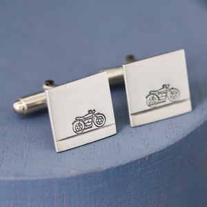 Silver motorbike cufflinks on deep blue background, thoughtful birthday gift ideas for a biker dad