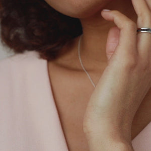 Video showing an oxidised silver pearl ring worn as part of a jewellery stack