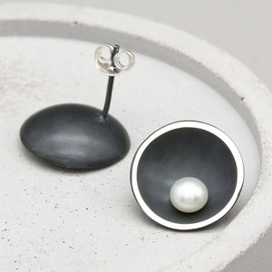 Signature black pearl stud earrings with polished freshwater pearls set in oxidised sterling silver domes.