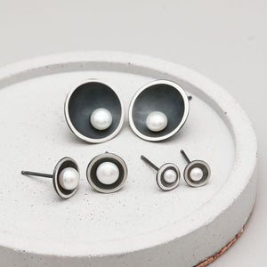 Size comparison of Petite, Classic and Signature black pearl stud earrings in handcrafted oxidised sterling silver.