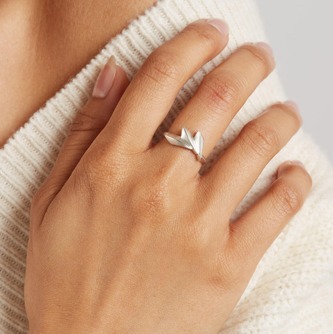 Art Deco silver ring worn on a woman's hand, showing how the geometric fan shape creates a distinctive statement look