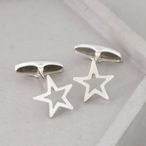 Detailed view of handcrafted silver Star cufflinks on a grey ceramic dish – a timeless and personal graduation gift for son.
