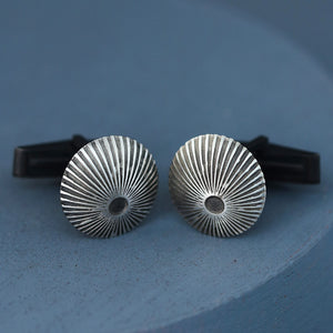 Silver and black cufflinks with engraved Art Deco design photographed on deep blue background, ideal mens luxury cufflinks for wedding day style.