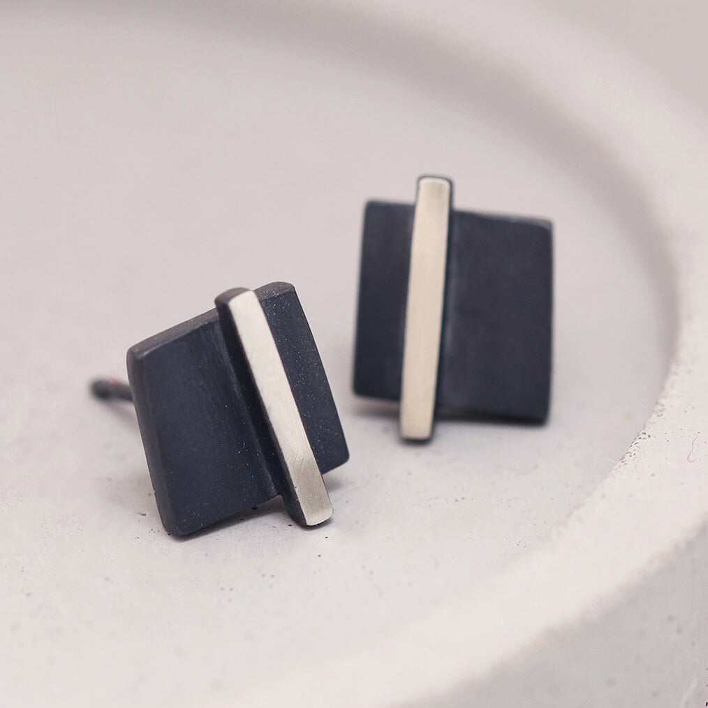 Silver and black earrings displayed on a grey dish showing the geometric square design, ideal birthday gift for her.