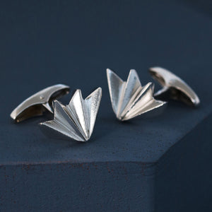 Close-up showing art deco cufflink design on deep blue background, luxury men’s silver cufflinks perfect for anniversary or milestone gift