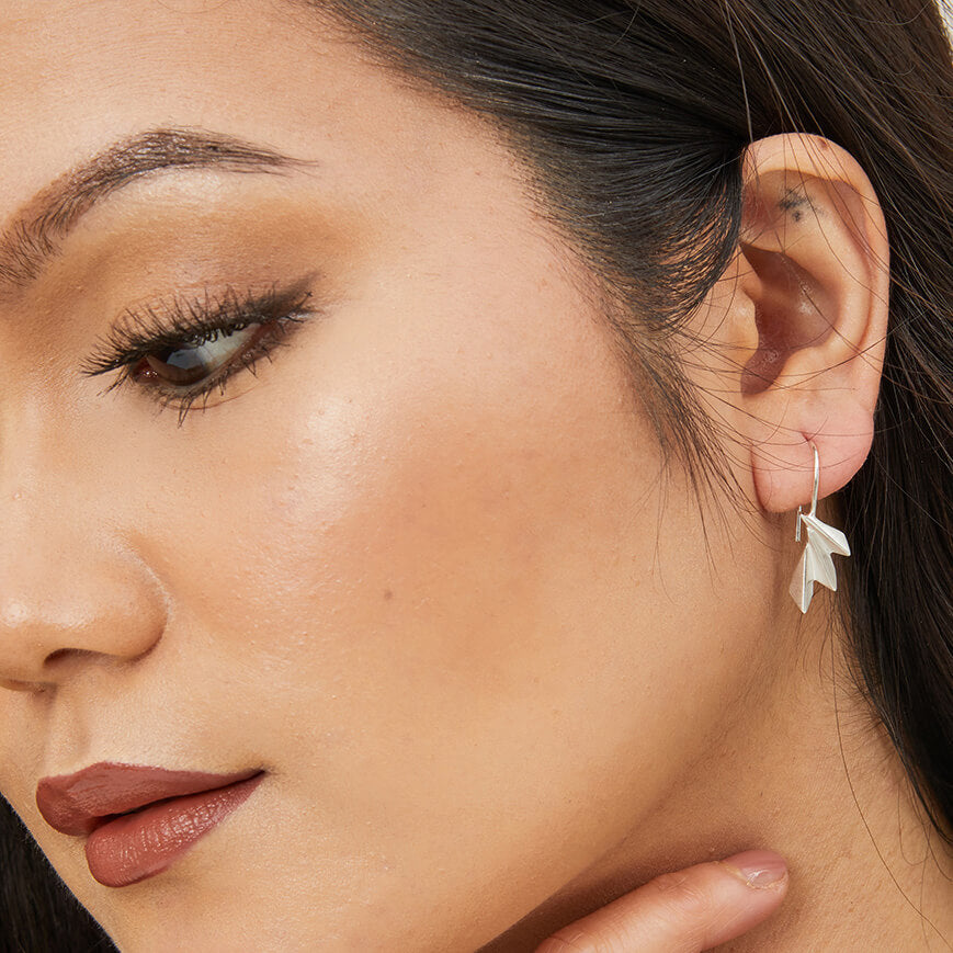 Model wearing fan drop earrings paired with a simple neckline, showcasing their art deco elegance; ideal gift for her.