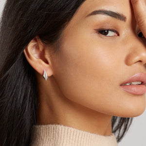 Model wearing silver art deco earrings showing size and placement of art deco earrings studs.