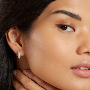 Close-up of art deco earrings studs worn by model highlighting size and shape