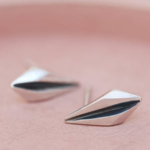Art deco earrings studs photographed on pink dish for anniversary or birthday gifting.