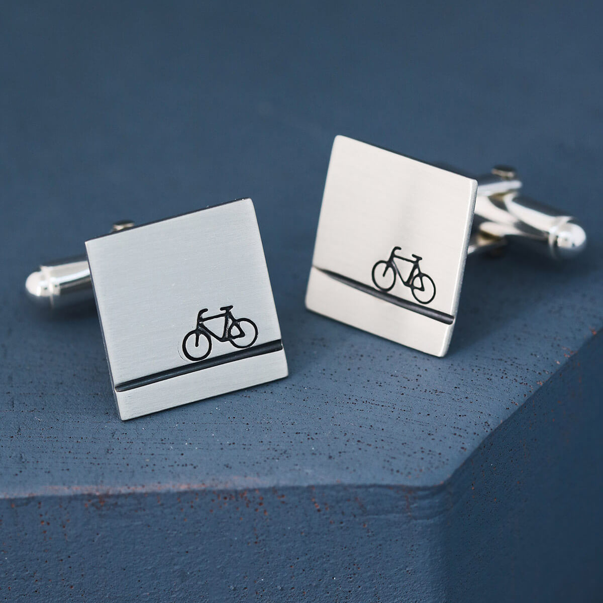 Single cufflink turned to show engraved message on reverse, stylish bike cufflinks and heartfelt cycling gifts for him for special occasions.