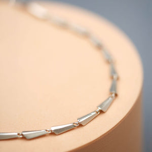 Silver chain link necklace in polished sterling silver, showing the substantial links and fluid construction