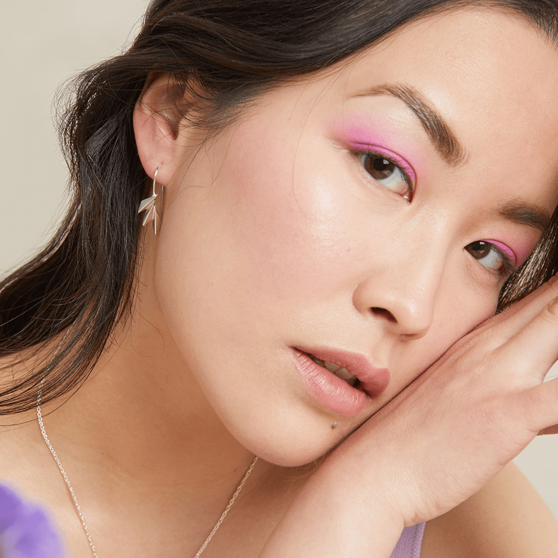 Art deco drop earrings modelled with soft waves, highlighting the bold fan shape; perfect anniversary or Valentine’s gift.