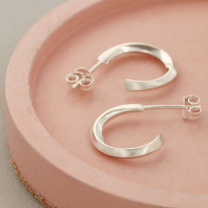 Minimal silver hoop stud earrings styled on a pink dish, sterling silver hoop earrings for women birthday gift
