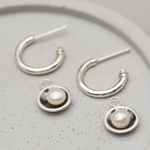 Oxidised sterling silver black pearl hoop earrings with genuine freshwater pearl charms for versatile everyday wear.